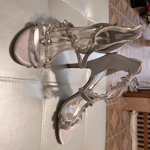 Silver dress shoes with rhinestone accents.